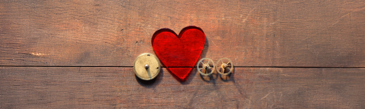 heart carved in wood with gears around it